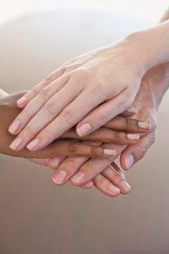 Four hands atop one another Stock Photos