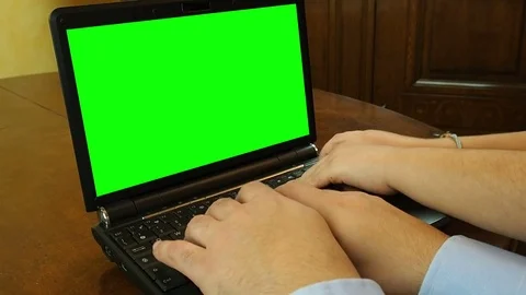 Four hands typing on keyboard laptop with green screen Stock Footage 72685226