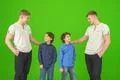The four happy brothers stand on the green background Photo