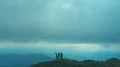 The four happy friends dance on the mountain peak 4k or 4k+ Resolution