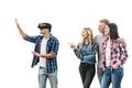 The four happy friends play with virtual reality glasses on a white backgroun Photo
