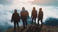 The four happy people standing on the beautiful mountain 4k or 4k+ Resolution