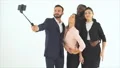 The four happy people taking selfie on the white background. slow motion 4k or 4k+ Resolution