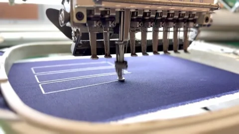 Four-head embroidery machine stitching fabric with needle in close-up 스톡 동영상 338282997