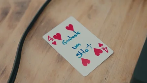 Four of Hearts Playing Card with Handwritten Message on Wooden Table Stock Footage 332948805