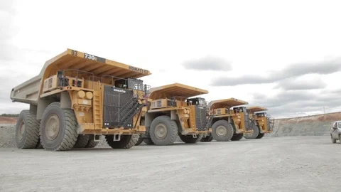 Four heavy dump trucks and service car Stock Footage 83537353