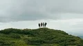 The four hikers standing on a beautiful mountain 4k or 4k+ Resolution