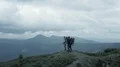 The four hikers standing on a mountain 4k or 4k+ Resolution