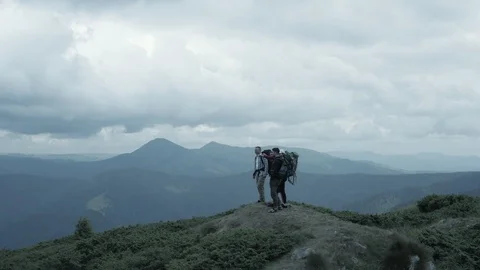 The four hikers standing on a mountain Stock-Footage 116077463