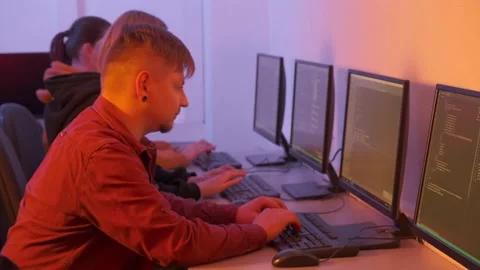 Four human programmers get to work and quickly prescribe the code on the PC. Stock Footage 147626726