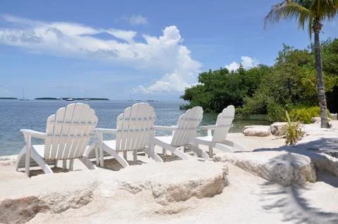 Four Inviting Chairs on the Beach Stock Photos