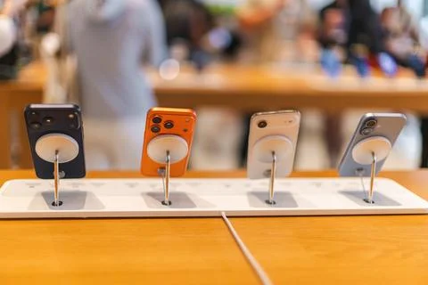 Four iPhone 16 Smartphones on Security Display Stands Stock Photos