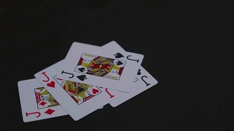 Four jack poker cards falling on the black table Video stock 77041868