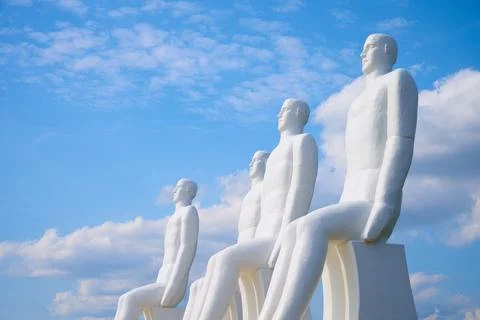 Four large white statues known as "Men at Sea." Stock Photos