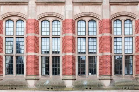 Four large windows in an old brick building Stock Photos