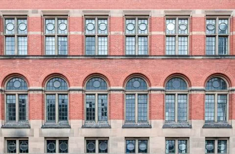 Four large windows in an old brick building Stock Photos
