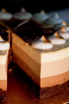 Four layer cake with shades of brown.Here cream to chocolate. Stock Photos