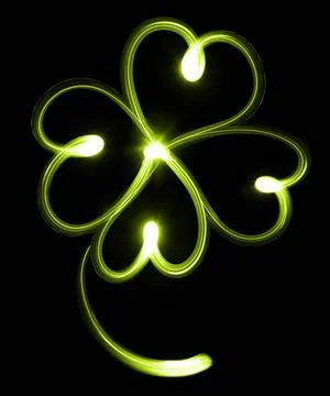 Four-leaf clover Four-leaf clover over black background. St. Patrick s day... Stock Photos