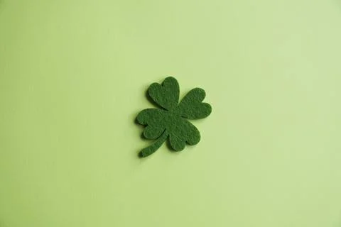 Four-leaf clover made from felt on green background Stock Photos