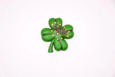 Four-leaf clover on white background with text A Little Irish Luck Stock Photos