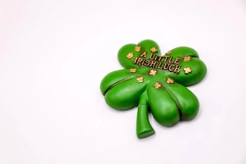 Four-leaf clover on white background with text A Little Irish Luck Fotos de archivo