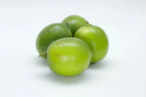Four lemons on a white background, placing one in front, this one with light Stock Photos