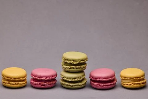 Four macarons assorted colors on gray background Stock Photos