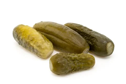 Four marinated cucumbers on white Stock Photos