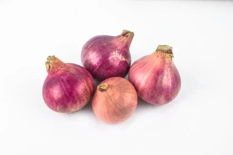 Four medium size fresh and ripe red onion isolated on a white background Stock Photos