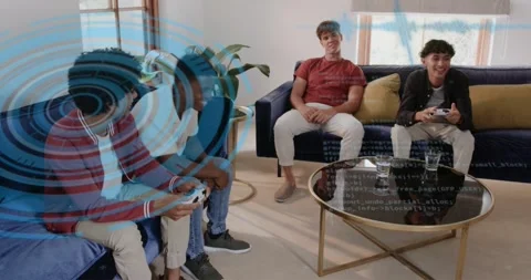 Four men gaming on couch, using controllers and causing blue rings and code Stock Footage 323173692