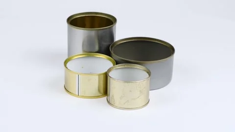 Four metal cans on a white background. Side view. Loop motion. Stock Footage 245076906
