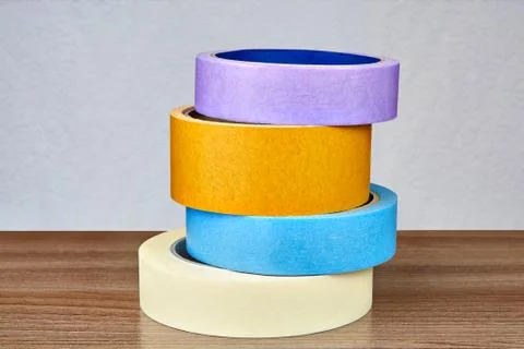 Four multi-colored adhesive tapes are stacked one above the other. Stock Photos