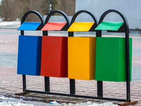 Four multi-colored garbage bins for separate waste collection Stock Photos