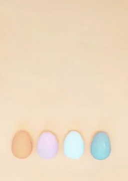 Four multi-colored handmade eggs on pink ackground. Stock Photos