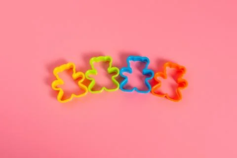 Four multi-colored plastic cookie cutters for making cookies in the form of a Stock-Fotos