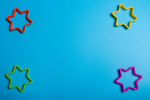 Four multi-colored plastic cookie cutter for making cookies in the shape of s Stock Photos