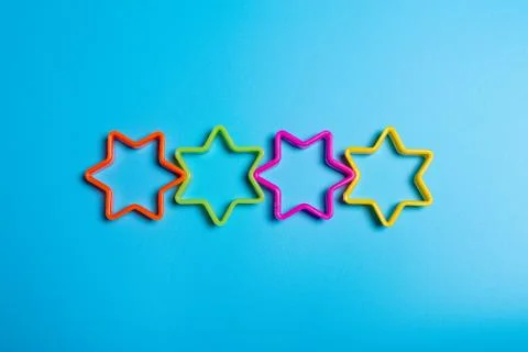 Four multi-colored plastic cookie cutter for making cookies in the shape of s Stock Photos