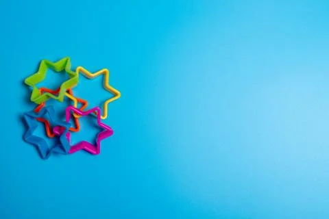 Four multi-colored plastic cookie cutter for making cookies in the shape of s Stock Photos