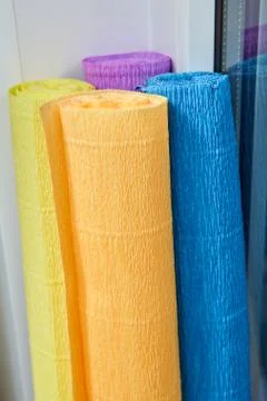 Four multi-colored rolls of wrinkled paper for needlework. Stock Photos