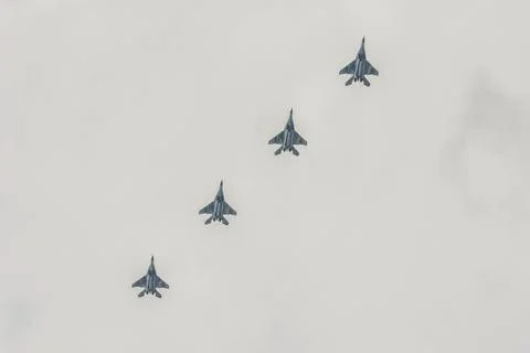 Four multi-purpose fighters SU-27 in the cloudy sky. Stock Photos