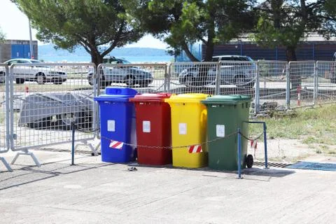 Four multicolored boxes for sorted garbage: red, green, blue and yellow. Recy Stock Photos