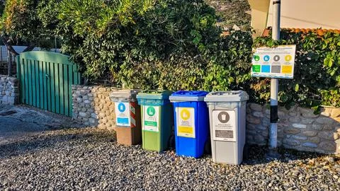 Four multicolored garbage sorting containers in the beach. Environmental Stock Photos