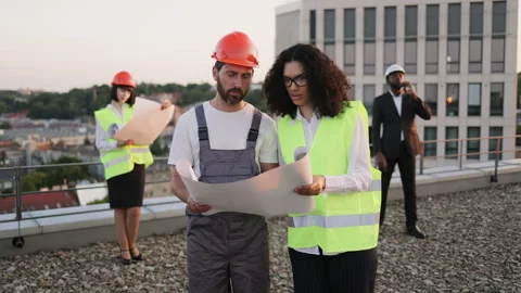 Four multicultural professionals meeting at building site Stock Footage 246129329