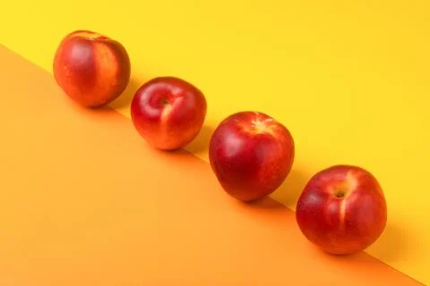 Four nectarines Stock Photos