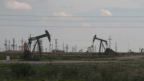 Four oil pumps working set within multiple electric power lines, 4K. Stock Footage 79976374
