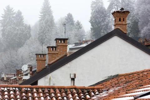 Four old chimneys made of bricks under the snow during winter Stock Photos