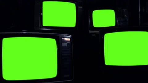 Four Old Television Sets turning on Green Screen in a Dark Room. Zoom Out. Stock Footage