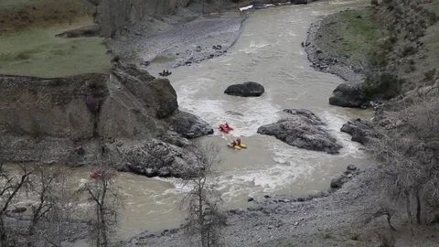 Four pairs of people run down the wild river on the twin-hull boats and drifting Stock Footage 83964218