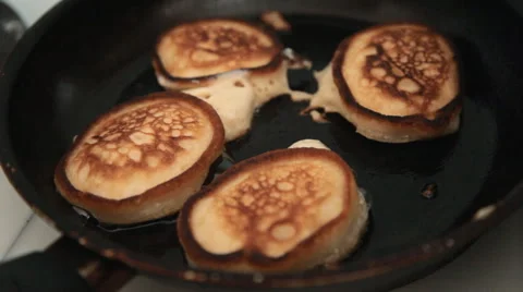 Four pancakes with a crust fried in a pan Stock-Footage 64732931
