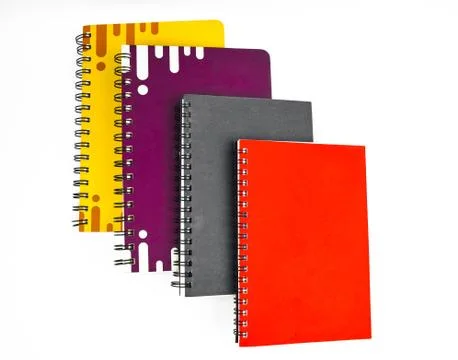 Four paper note diary of red black purple and yellow color placed on top of e Stock Photos